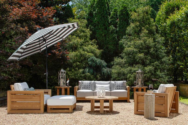 An outdoor seating area partially shaded by a large umbrella